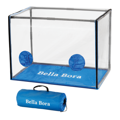 A transparent Bella Bora Still Air Box set up with blue elastic arm ports against a white background, accompanied by its portable blue carrying case with the Bella Bora logo.