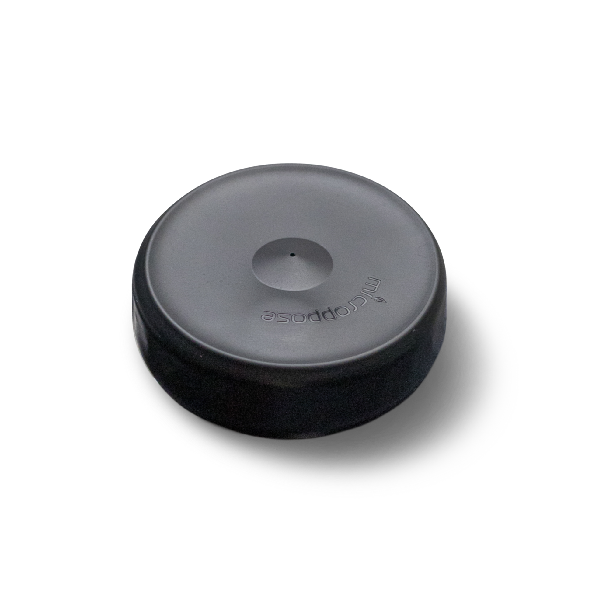 An isolated image of a black Microppose silicone jar cover with a single central hole, displayed against a white background for clear visibility.